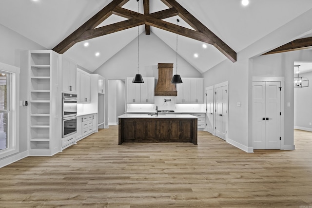 1500 Haley Ln, Conway, AR 72034 - kitchen featuring custom exhaust hood, double oven, light countertops, light wood-style floors, and white cabinets