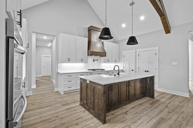 1500 Haley Ln, Conway, AR 72034 - kitchen with premium range hood, high vaulted ceiling, light countertops, white cabinets, and oven