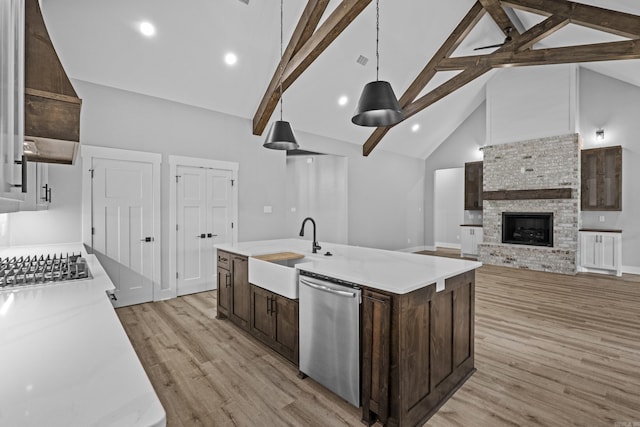 1500 Haley Ln, Conway, AR 72034 - kitchen featuring appliances with stainless steel finishes, dark brown cabinets, high vaulted ceiling, light wood-type flooring, and open floor plan
