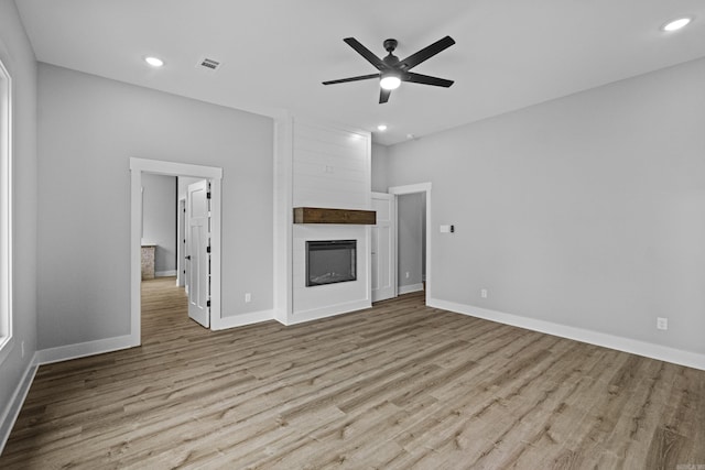 1500 Haley Ln, Conway, AR 72034 - unfurnished living room with wood finished floors, ceiling fan, a fireplace, and recessed lighting