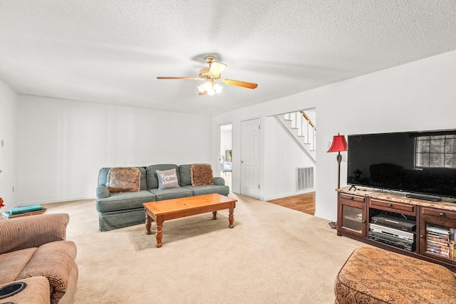 114 Woodiel Cir, Cabot, AR 72023 - living area featuring stairs, carpet flooring, ceiling fan, and a textured ceiling
