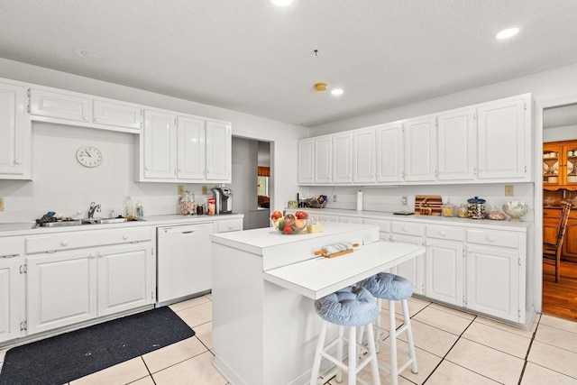 114 Woodiel Cir, Cabot, AR 72023 - kitchen featuring dishwasher, light countertops, white cabinets, a kitchen island, and light tile patterned flooring