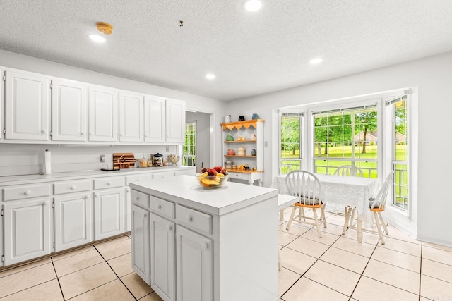 114 Woodiel Cir, Cabot, AR 72023 - kitchen featuring light countertops, white cabinets, a center island, light tile patterned flooring, and recessed lighting