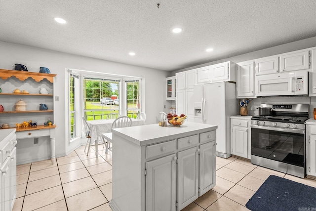 114 Woodiel Cir, Cabot, AR 72023 - kitchen with white appliances, light countertops, recessed lighting, a kitchen island, and light tile patterned floors