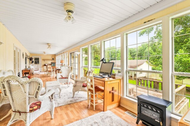 114 Woodiel Cir, Cabot, AR 72023 - sunroom / solarium with plenty of natural light, a wood stove, and wood finished floors