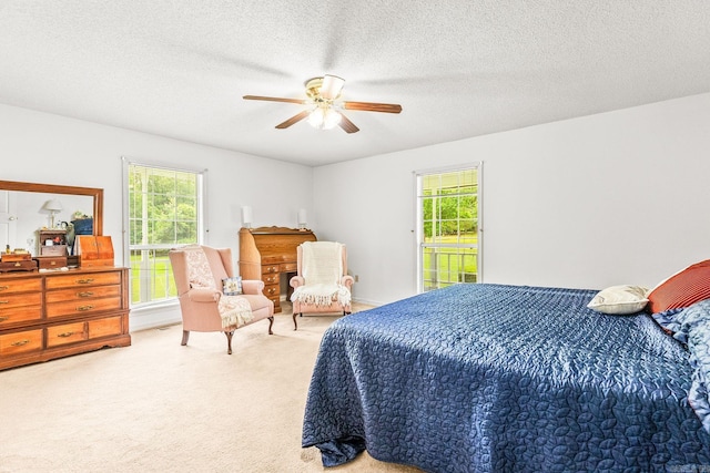 114 Woodiel Cir, Cabot, AR 72023 - bedroom with multiple windows, light colored carpet, a ceiling fan, a textured ceiling, and access to exterior
