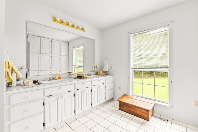 114 Woodiel Cir, Cabot, AR 72023 - full bath featuring double vanity, a textured ceiling, and tile patterned flooring