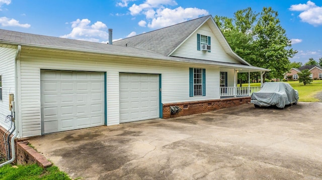 114 Woodiel Cir, Cabot, AR 72023 - view of property exterior with a garage, driveway, a porch, cooling unit, and a shingled roof