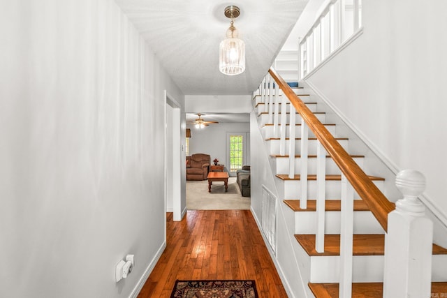 114 Woodiel Cir, Cabot, AR 72023 - stairs featuring wood-type flooring, a chandelier, and a ceiling fan