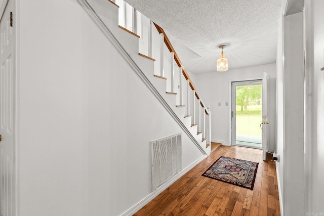 114 Woodiel Cir, Cabot, AR 72023 - foyer with a textured ceiling, light wood finished floors, and stairway