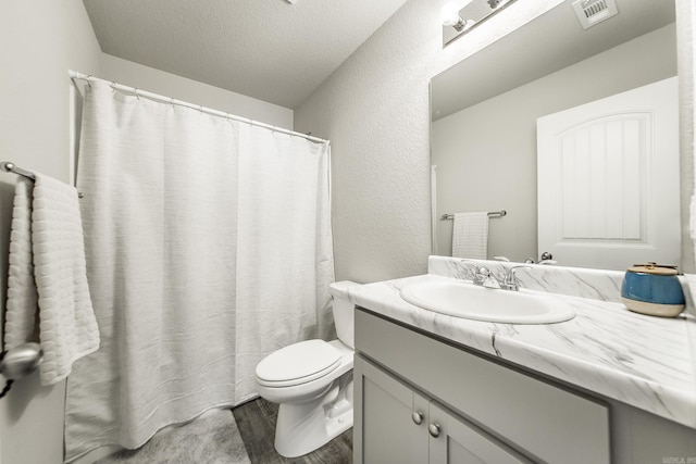 53 Dunnaway Dr, Ward, AR 72176 - bathroom with wood finished floors, vanity, a textured ceiling, a textured wall, and a shower with shower curtain