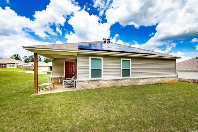 53 Dunnaway Dr, Ward, AR 72176 - back of property with solar panels, a patio area, and a yard
