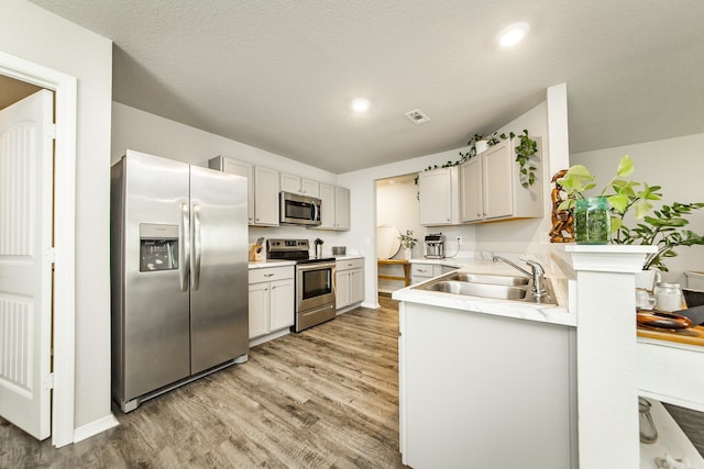 53 Dunnaway Dr, Ward, AR 72176 - kitchen featuring appliances with stainless steel finishes, light wood-style floors, light countertops, and recessed lighting