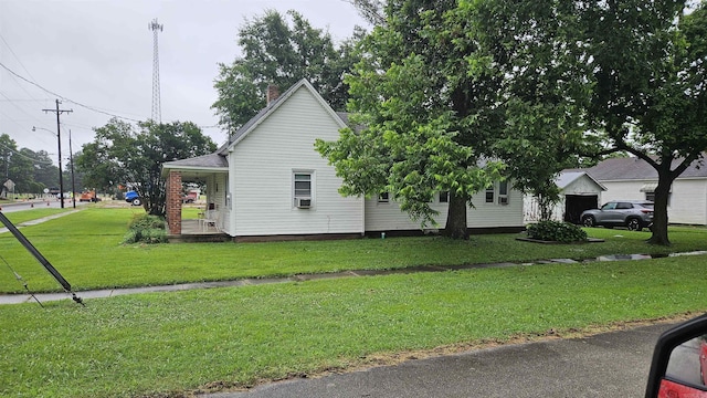 121 W 5th St, Rector, AR 72461 - view of side of property with a yard and a chimney