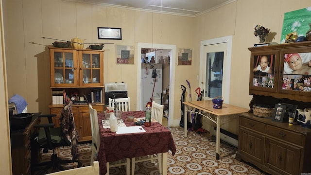 121 W 5th St, Rector, AR 72461 - dining room featuring heating unit and ornamental molding