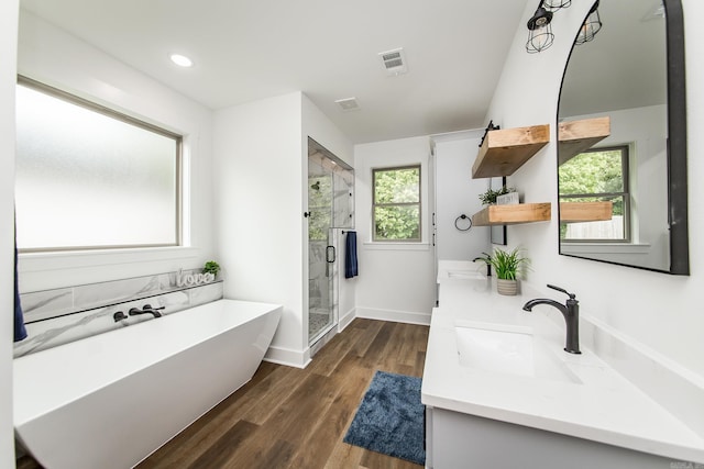 19 Denali Dr, Cabot, AR 72023 - full bathroom featuring double vanity, a freestanding bath, a shower stall, wood finished floors, and recessed lighting