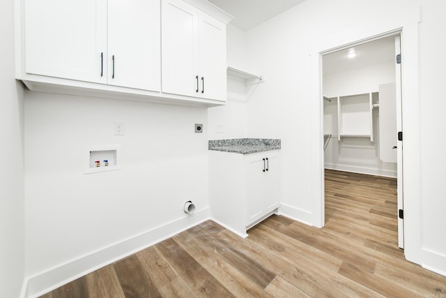 19 Denali Dr, Cabot, AR 72023 - laundry room featuring hookup for an electric dryer, light wood-style flooring, washer hookup, and cabinet space
