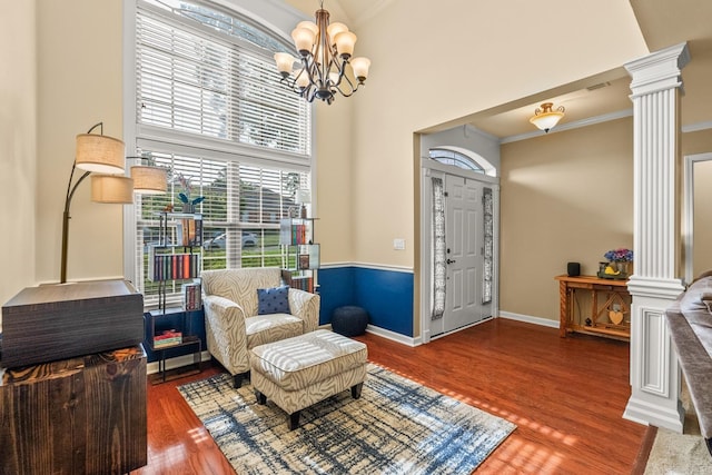 181 Diamond Pointe Dr, Maumelle, AR 72113 - sitting room with decorative columns, plenty of natural light, wood finished floors, a chandelier, and crown molding