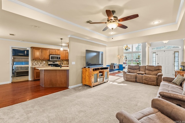 181 Diamond Pointe Dr, Maumelle, AR 72113 - living room with dark colored carpet, crown molding, a raised ceiling, ceiling fan, and ornate columns