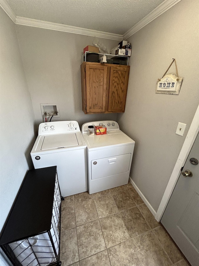 497 Law 611, Walnut Ridge, AR 72476 - laundry room featuring washing machine and clothes dryer, crown molding, a textured ceiling, and cabinet space