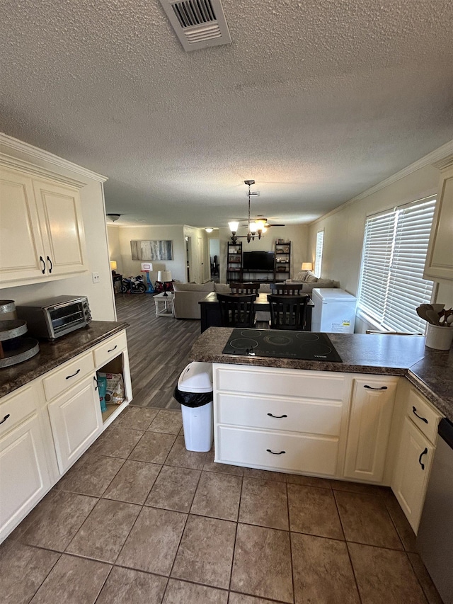 497 Law 611, Walnut Ridge, AR 72476 - kitchen with open floor plan, black electric cooktop, a peninsula, crown molding, and a textured ceiling