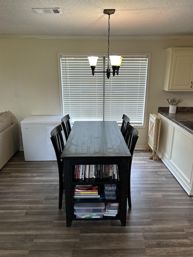 497 Law 611, Walnut Ridge, AR 72476 - dining room featuring a chandelier, ornamental molding, dark wood-style flooring, a textured ceiling, and plenty of natural light