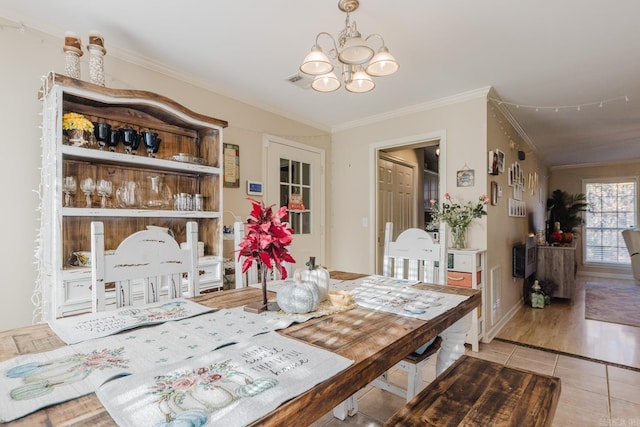 1304 Winbourne Dr, North Little Rock, AR 72116 - tiled dining area featuring a chandelier and crown molding