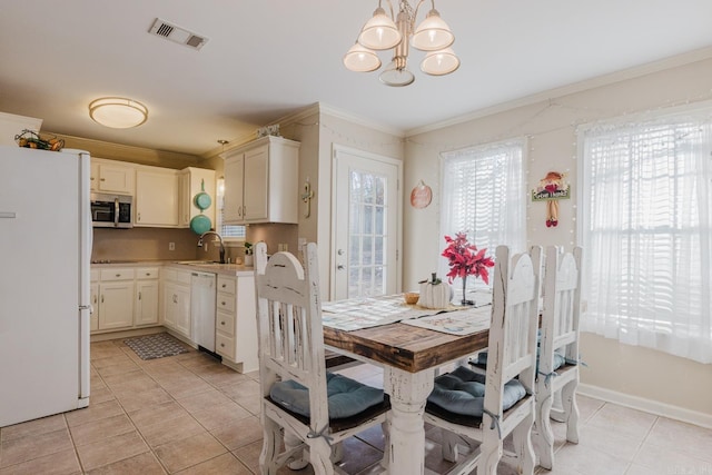 1304 Winbourne Dr, North Little Rock, AR 72116 - dining area featuring ornamental molding, light tile patterned flooring, and a chandelier