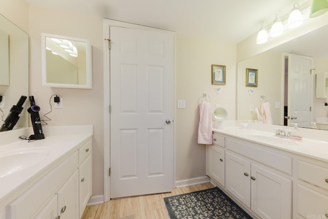 1304 Winbourne Dr, North Little Rock, AR 72116 - full bath featuring two vanities and wood finished floors
