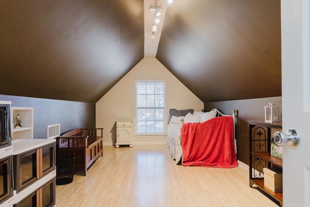 1304 Winbourne Dr, North Little Rock, AR 72116 - bedroom featuring wood finished floors and lofted ceiling