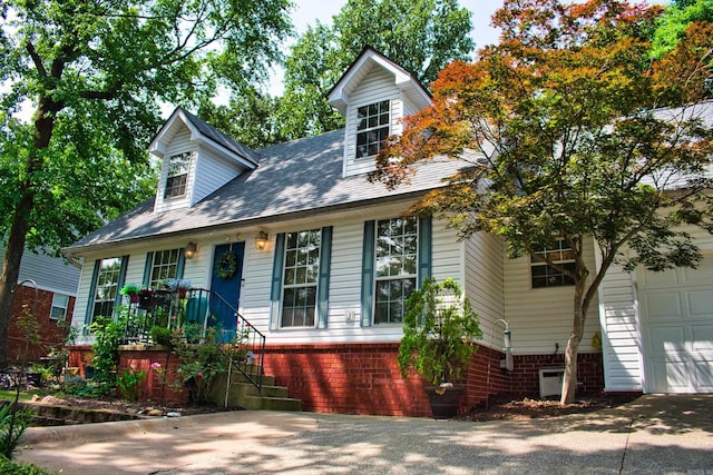 1304 Winbourne Dr, North Little Rock, AR 72116 - new england style home featuring an attached garage