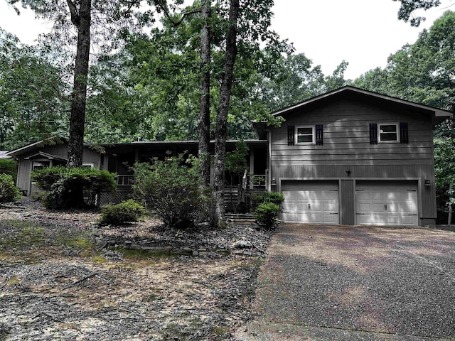 39 Dike View Dr, Heber Springs, AR 72543 - view of front of home with an attached garage, driveway, and view of scattered trees