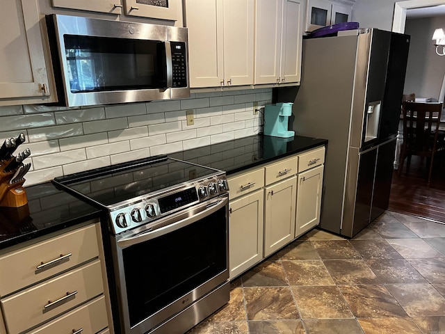 39 Dike View Dr, Heber Springs, AR 72543 - kitchen with appliances with stainless steel finishes, dark countertops, backsplash, and dark stone finish flooring