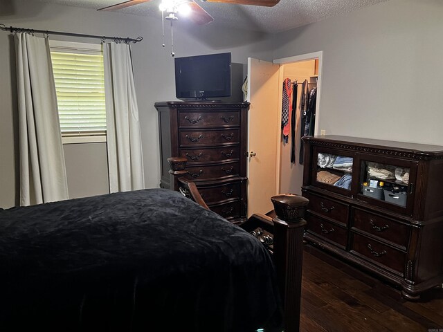 39 Dike View Dr, Heber Springs, AR 72543 - bedroom featuring dark wood-style flooring, a walk in closet, a textured ceiling, and a ceiling fan