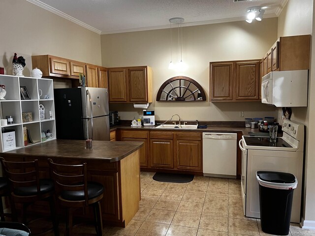 39 Dike View Dr, Heber Springs, AR 72543 - kitchen featuring white appliances, dark countertops, ornamental molding, brown cabinetry, and light tile patterned flooring