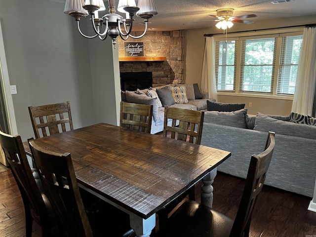39 Dike View Dr, Heber Springs, AR 72543 - dining space with wood finished floors, a ceiling fan, a chandelier, a fireplace, and a textured ceiling