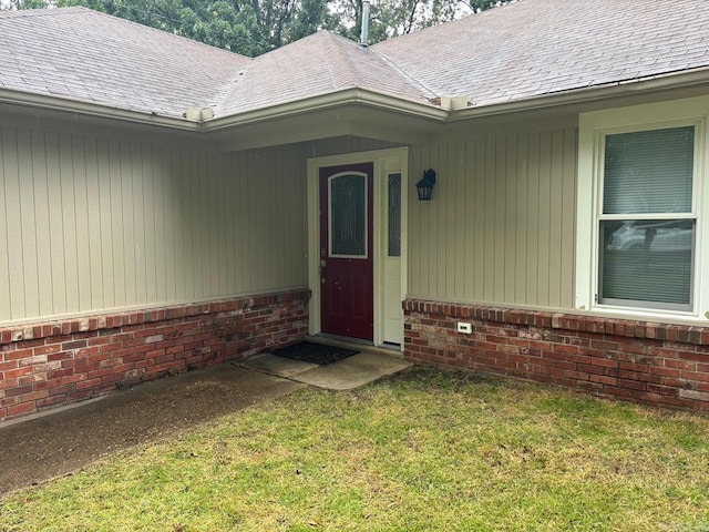 112 Sugar Maple Dr, Sherwood, AR 72120 - property entrance with brick siding, roof with shingles, and a yard