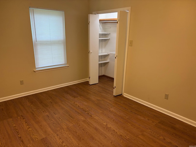 112 Sugar Maple Dr, Sherwood, AR 72120 - unfurnished bedroom with dark wood-style flooring, a spacious closet, and a closet