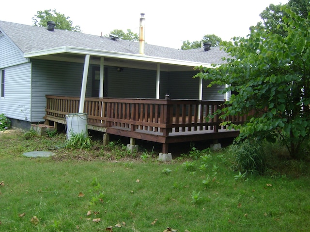 405 Fairway Dr, Horseshoe Bend, AR 72512 - back of property with roof with shingles, a deck, and a lawn
