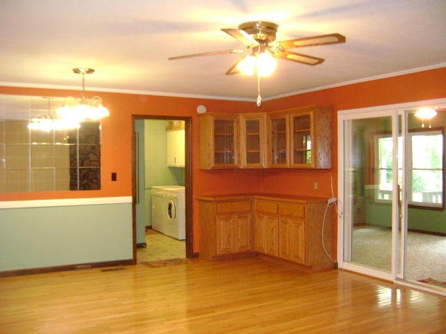 405 Fairway Dr, Horseshoe Bend, AR 72512 - kitchen featuring light wood finished floors, brown cabinets, ornamental molding, a chandelier, and a ceiling fan