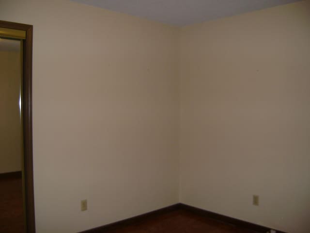 405 Fairway Dr, Horseshoe Bend, AR 72512 - spare room with dark wood-style flooring and baseboards