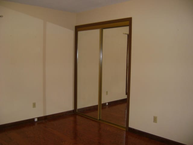 405 Fairway Dr, Horseshoe Bend, AR 72512 - unfurnished bedroom featuring a closet and wood finished floors