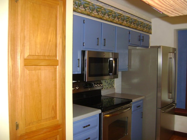 405 Fairway Dr, Horseshoe Bend, AR 72512 - kitchen with appliances with stainless steel finishes, blue cabinets, backsplash, and light countertops