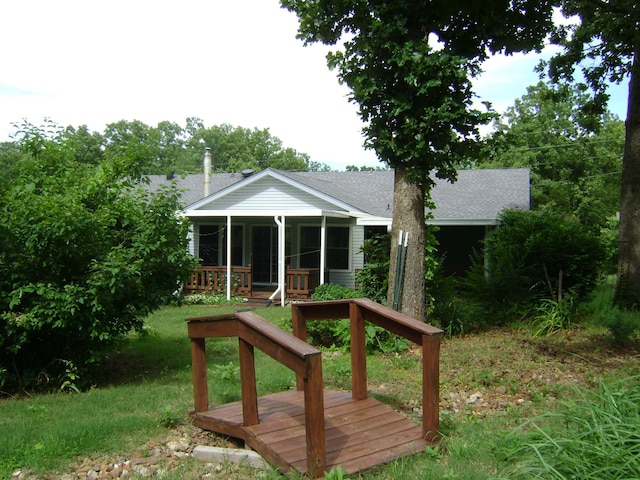 405 Fairway Dr, Horseshoe Bend, AR 72512 - rear view of property with a shingled roof and a sunroom
