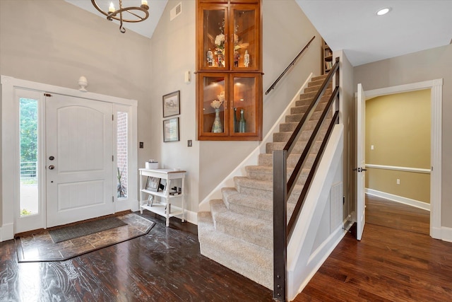 15355 Pleasant Grove Ln, Harrisburg, AR 72432 - entryway featuring stairway, wood finished floors, a chandelier, and a towering ceiling