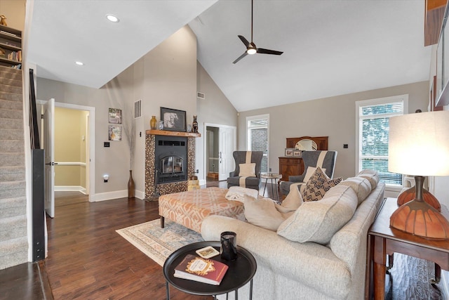 15355 Pleasant Grove Ln, Harrisburg, AR 72432 - living area with stairway, ceiling fan, dark wood finished floors, a tiled fireplace, and high vaulted ceiling