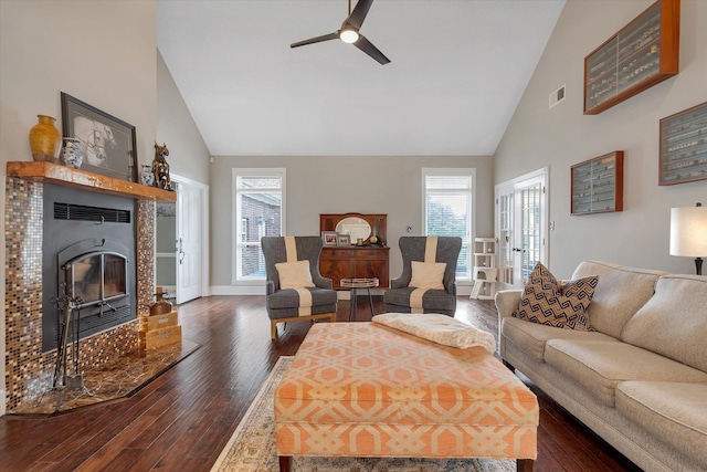 15355 Pleasant Grove Ln, Harrisburg, AR 72432 - living area with high vaulted ceiling, ceiling fan, dark wood-style floors, plenty of natural light, and a tiled fireplace