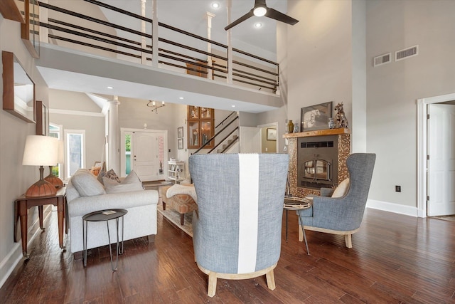 15355 Pleasant Grove Ln, Harrisburg, AR 72432 - living area featuring a towering ceiling, ceiling fan, stairway, wood finished floors, and a glass covered fireplace
