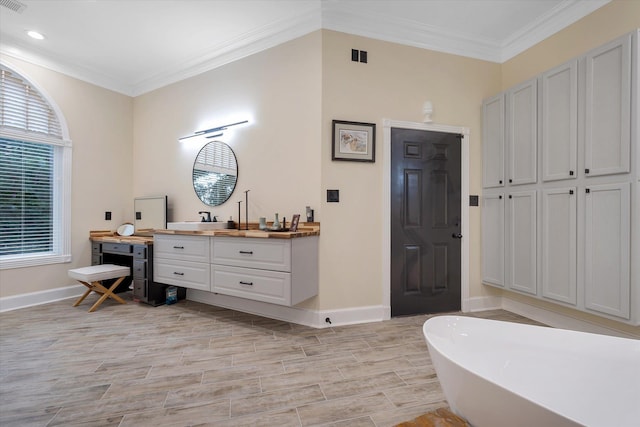 15355 Pleasant Grove Ln, Harrisburg, AR 72432 - bathroom with vanity, a soaking tub, ornamental molding, wood finished floors, and recessed lighting