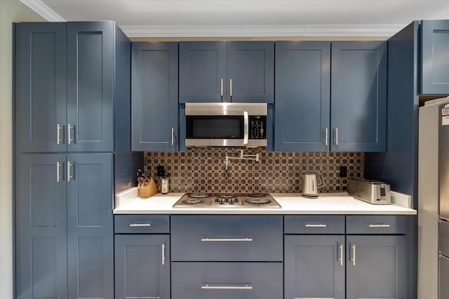 15355 Pleasant Grove Ln, Harrisburg, AR 72432 - kitchen with stainless steel appliances, light countertops, tasteful backsplash, crown molding, and blue cabinetry